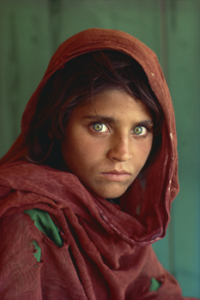 Steve McCurry; Afghan Border, Pakistan 1984. Haunting eyes and a tattered garment tell the plight of a girl who fled Afghanistan for a refugee camp in Pakistan. 